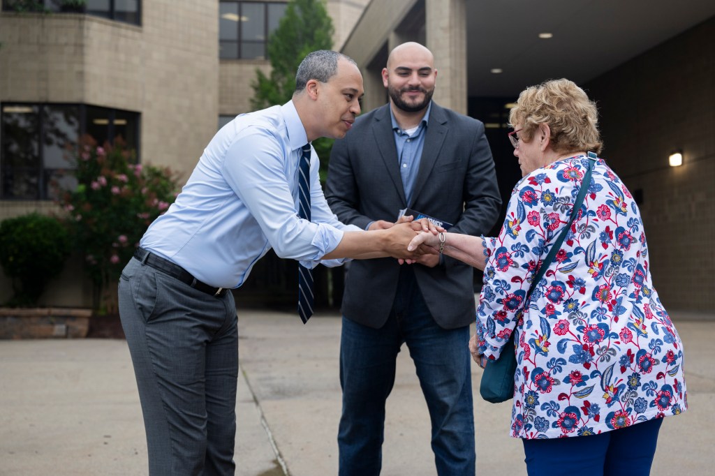 Virginia Attorney General Democratic candidate Jay Jones shakes hands with a voter.