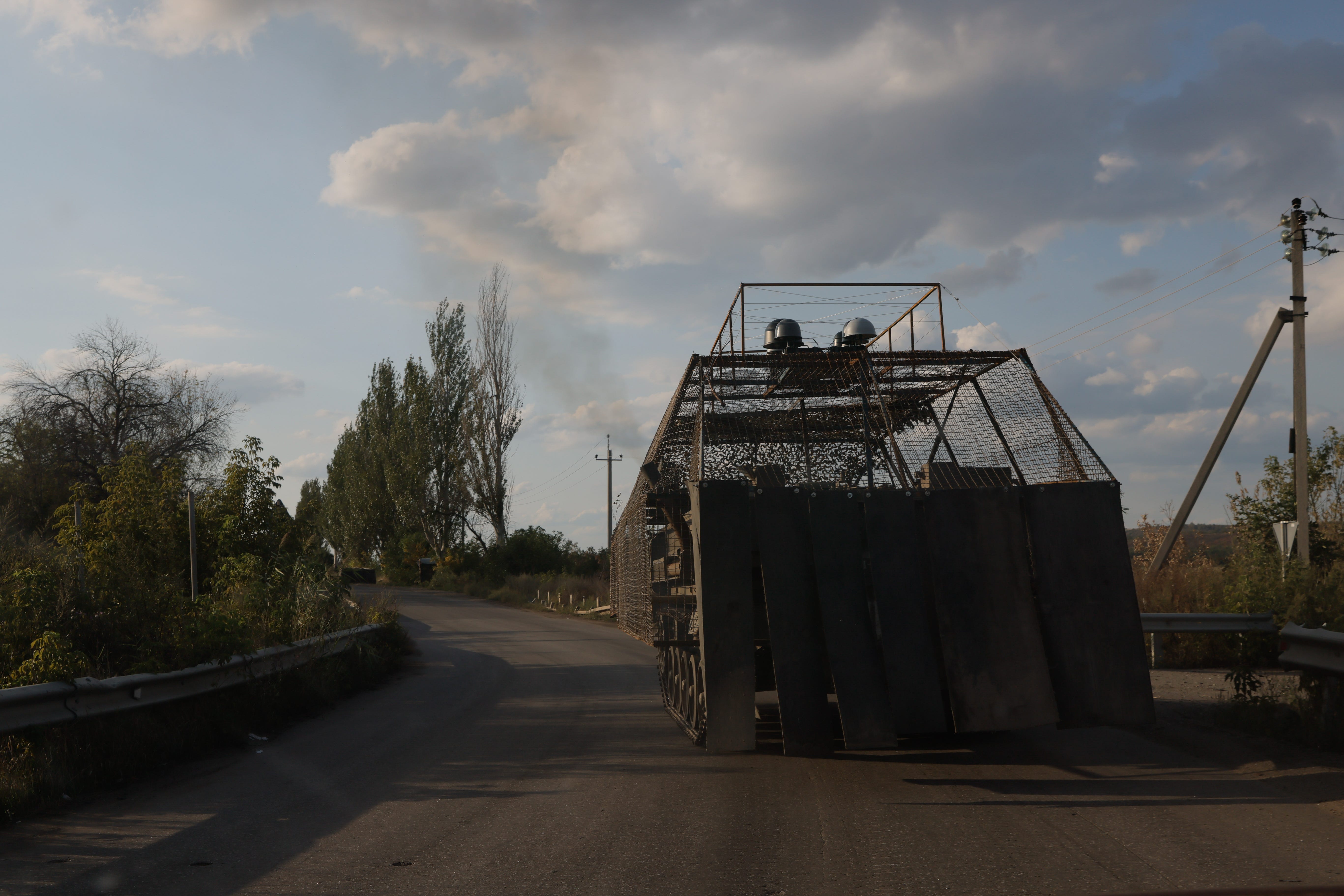 Ukrainian servicemen ride an M113 armored personnel carrier fitted with a metal protective net for protection against combat drones on August 24, 2025 in Kostiantynivka, Ukraine.