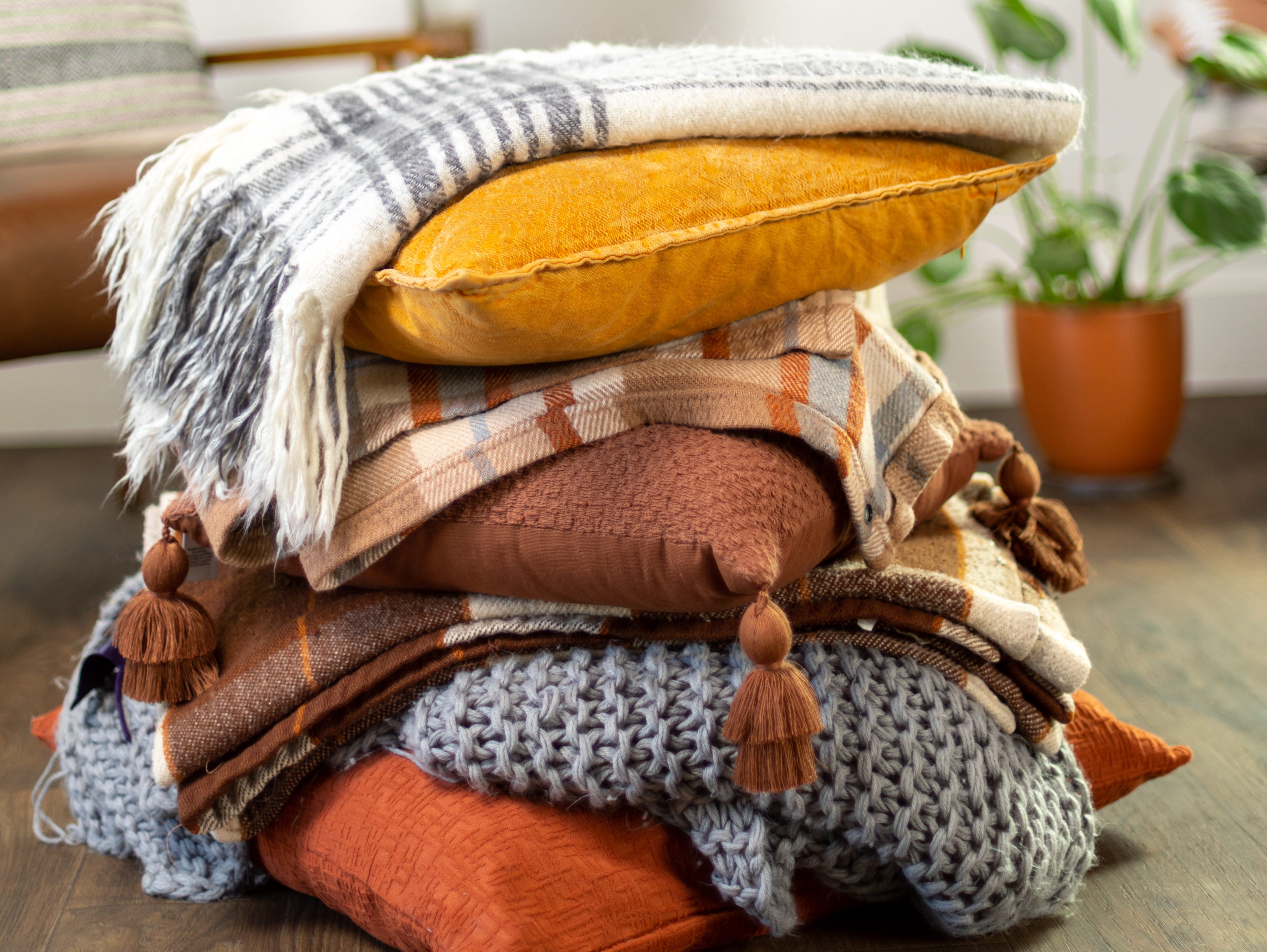 A stack of fall pillows and blankets