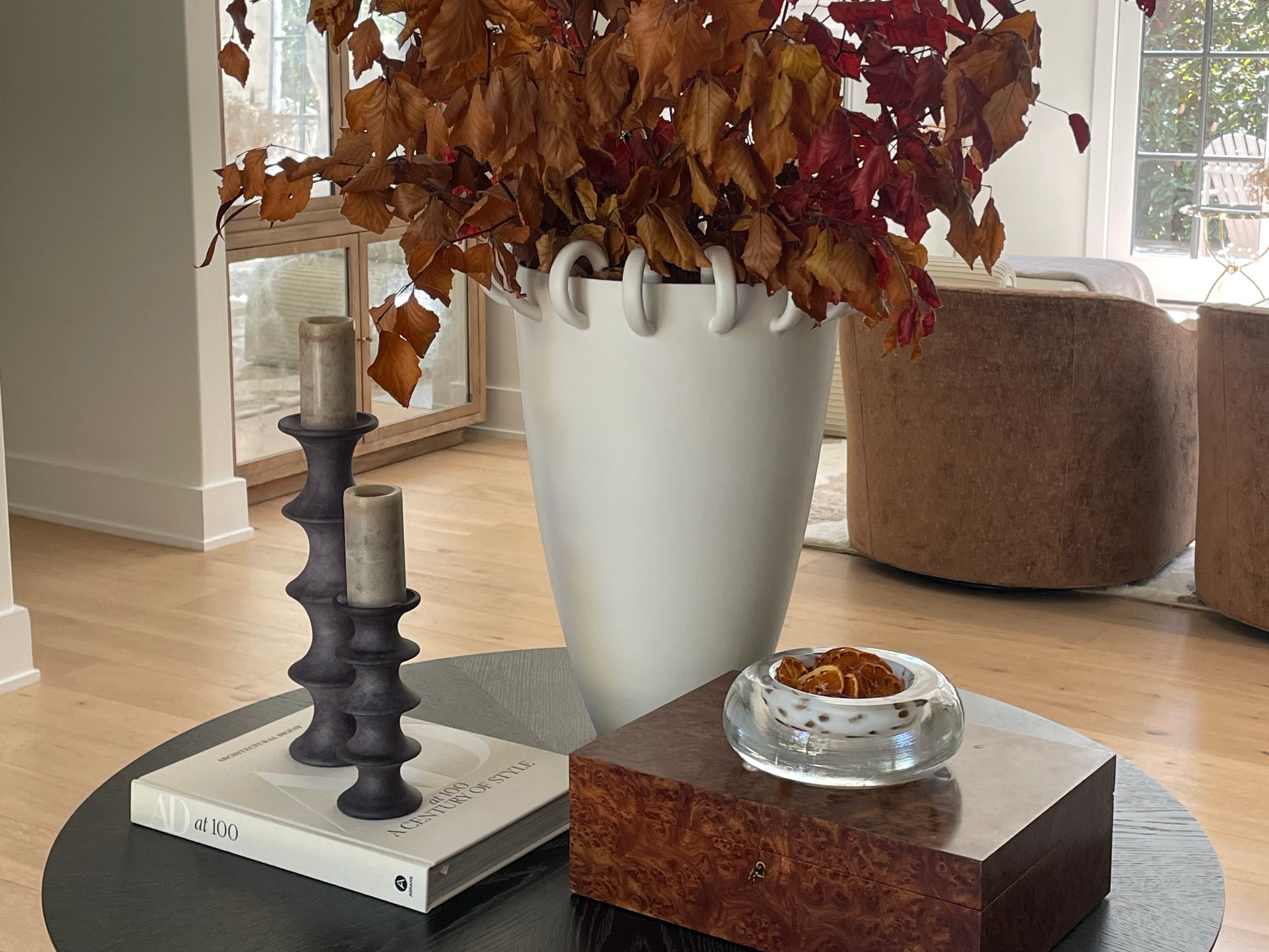 A vase with naturals on a table.