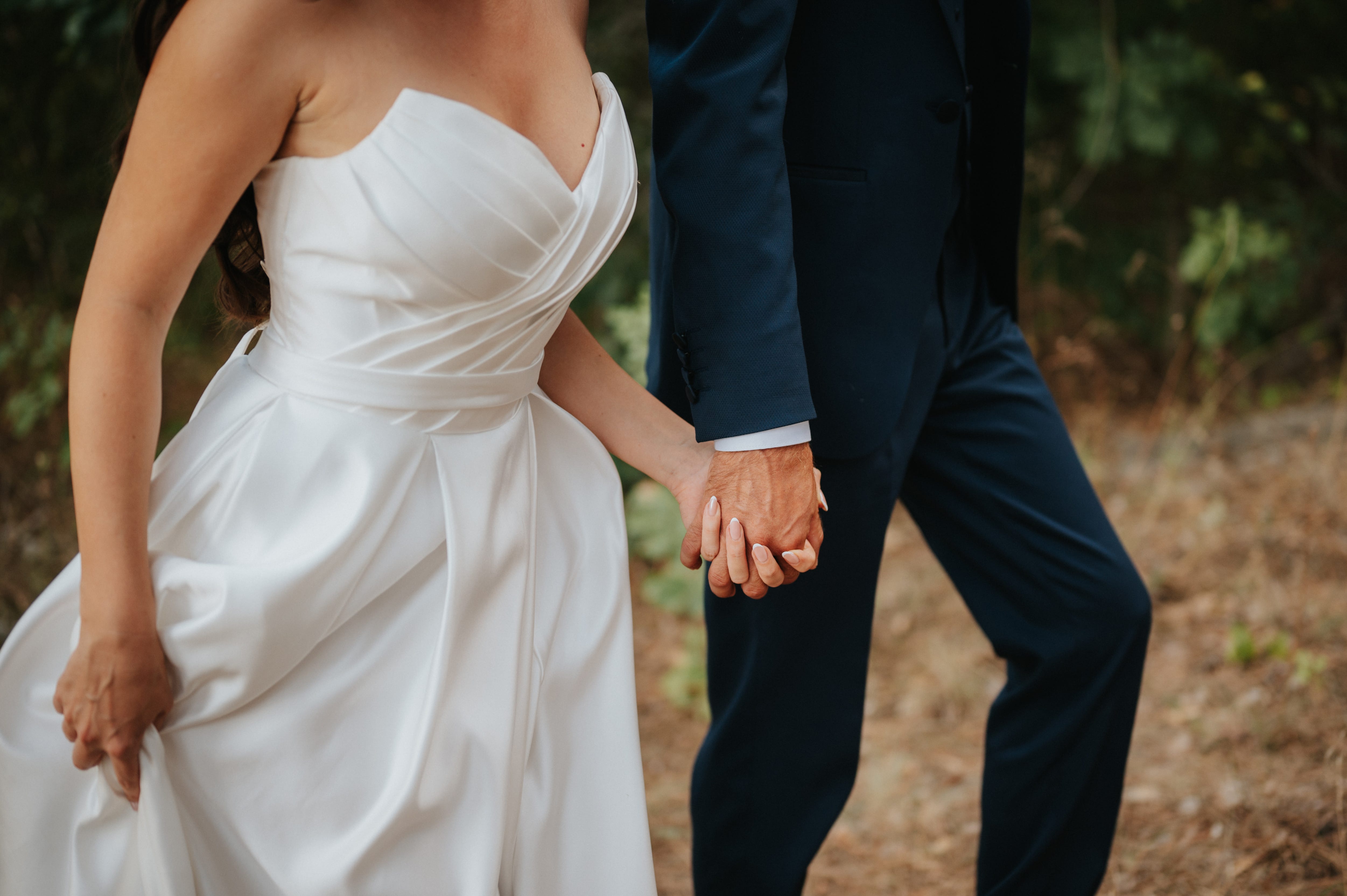 A bride and groom holding hands