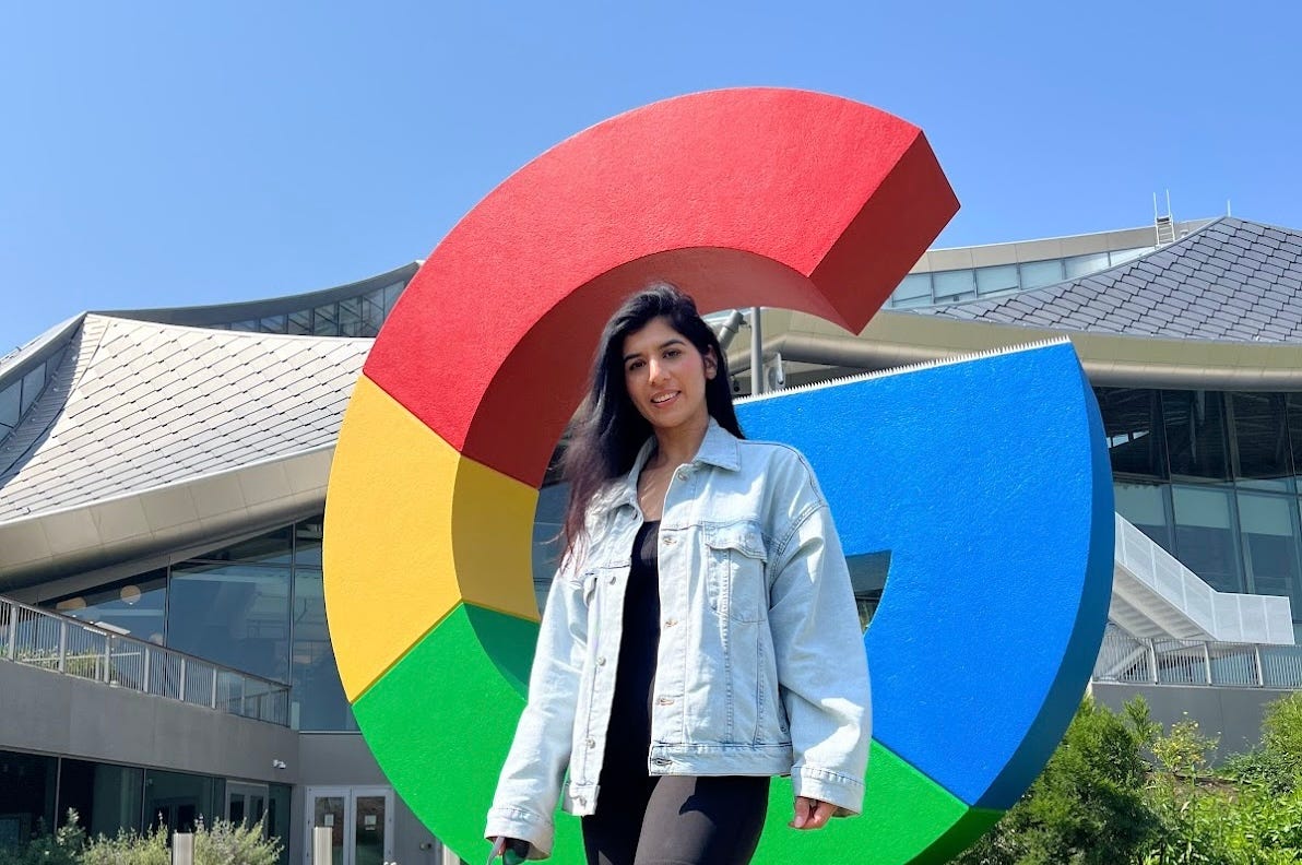 Sundas Khalid in front of a Google sign.