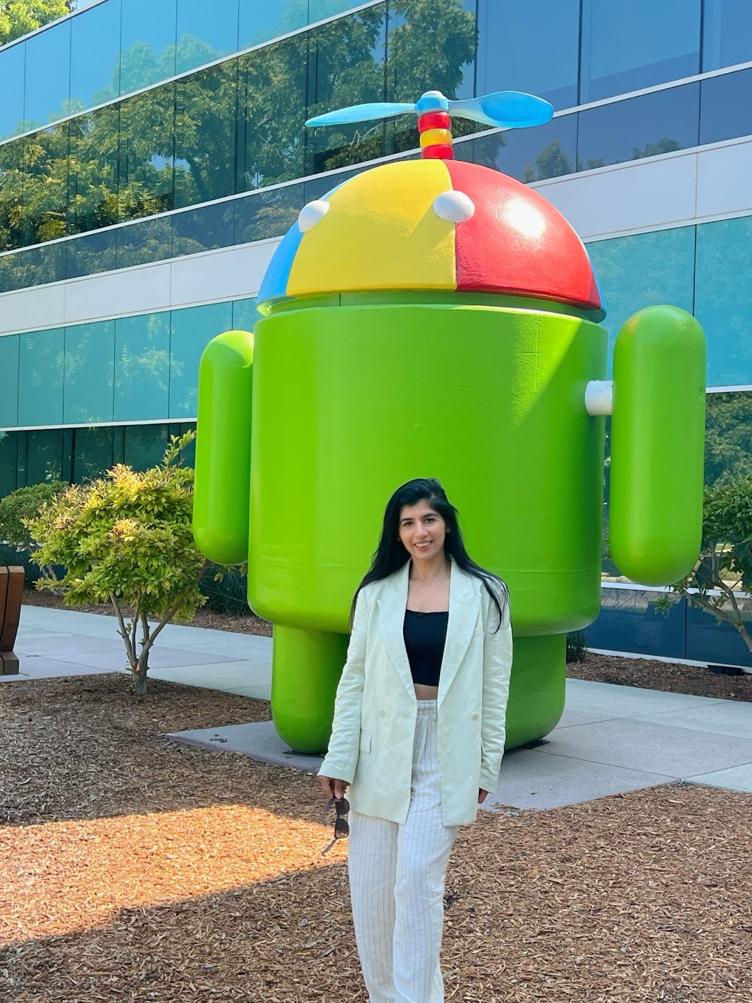 Sundas Khalid in front of a green statue.