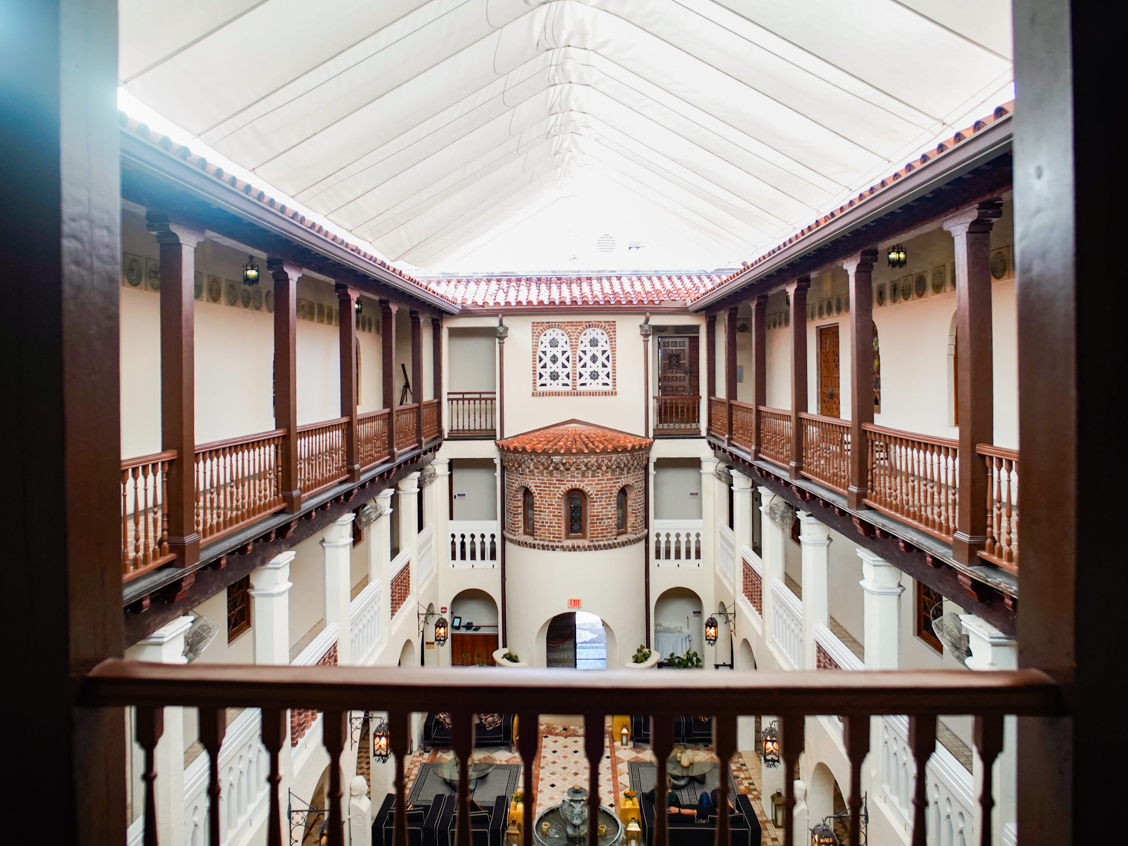 Inside the Versace Mansion, the glamorous lobby is seen from a balcony