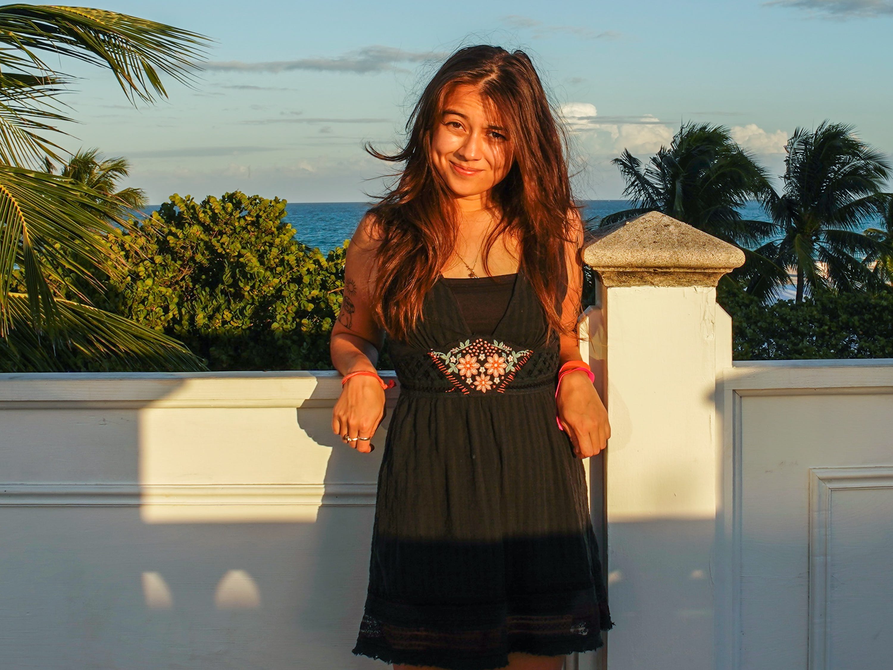 The author stands in front of the ocean on top of the versace mansion