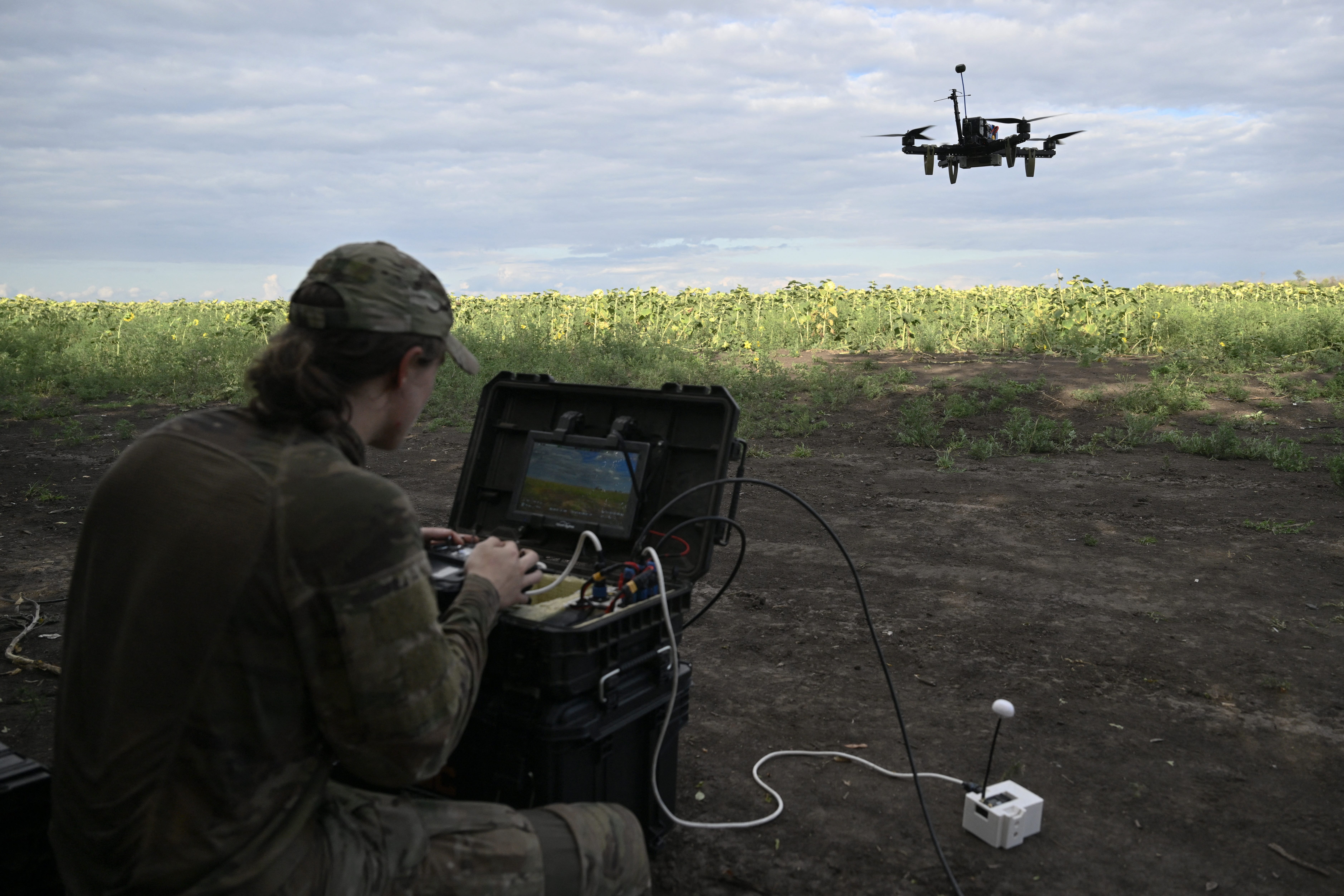 A drone pilot operates an FPV drone during a training flight in August 2025.
