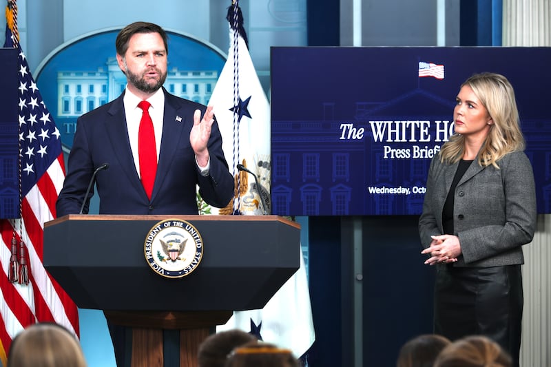 U.S. Vice President JD Vance speaks as White House Press Secretary Karoline Leavitt (R) looks on.
