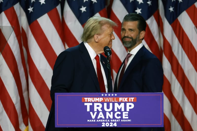 Donald Trump arrives to speak with Donald Trump Jr. during an election night event at the Palm Beach Convention Center on November 06, 2024 in West Palm Beach, Florida.