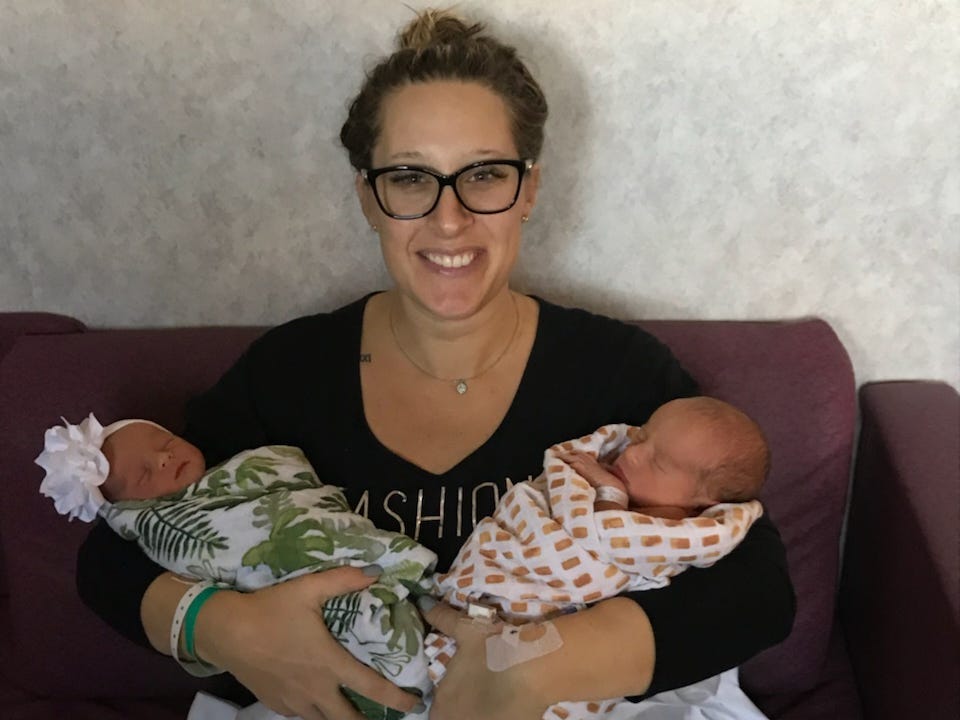 A woman holding twins