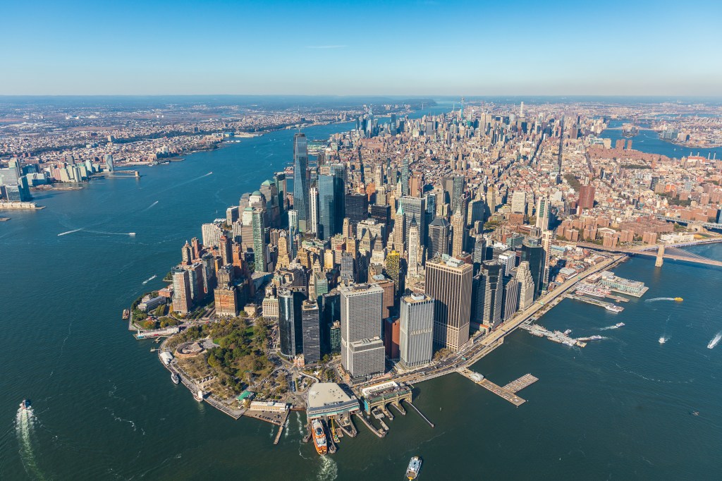 Aerial view of the New York City skyline with many buildings and rivers.