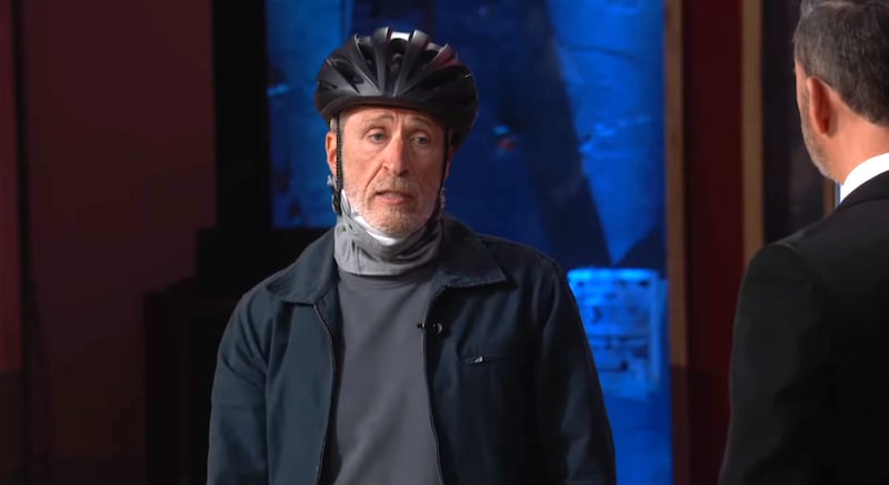The Daily Show, Jon Stewart with a helmet talking to Jimmy Kimmel.