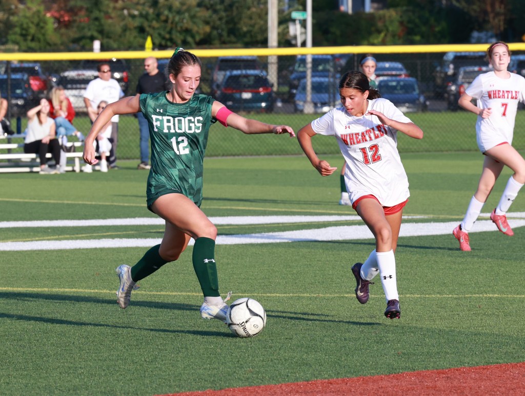 Three-sport star, Carle Place H.S. Junior Madison Reedy dribbles the soccer ball in a game.