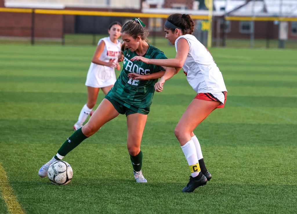 Madison Reedy has possession for the Frogs over an opponent during a game. 
