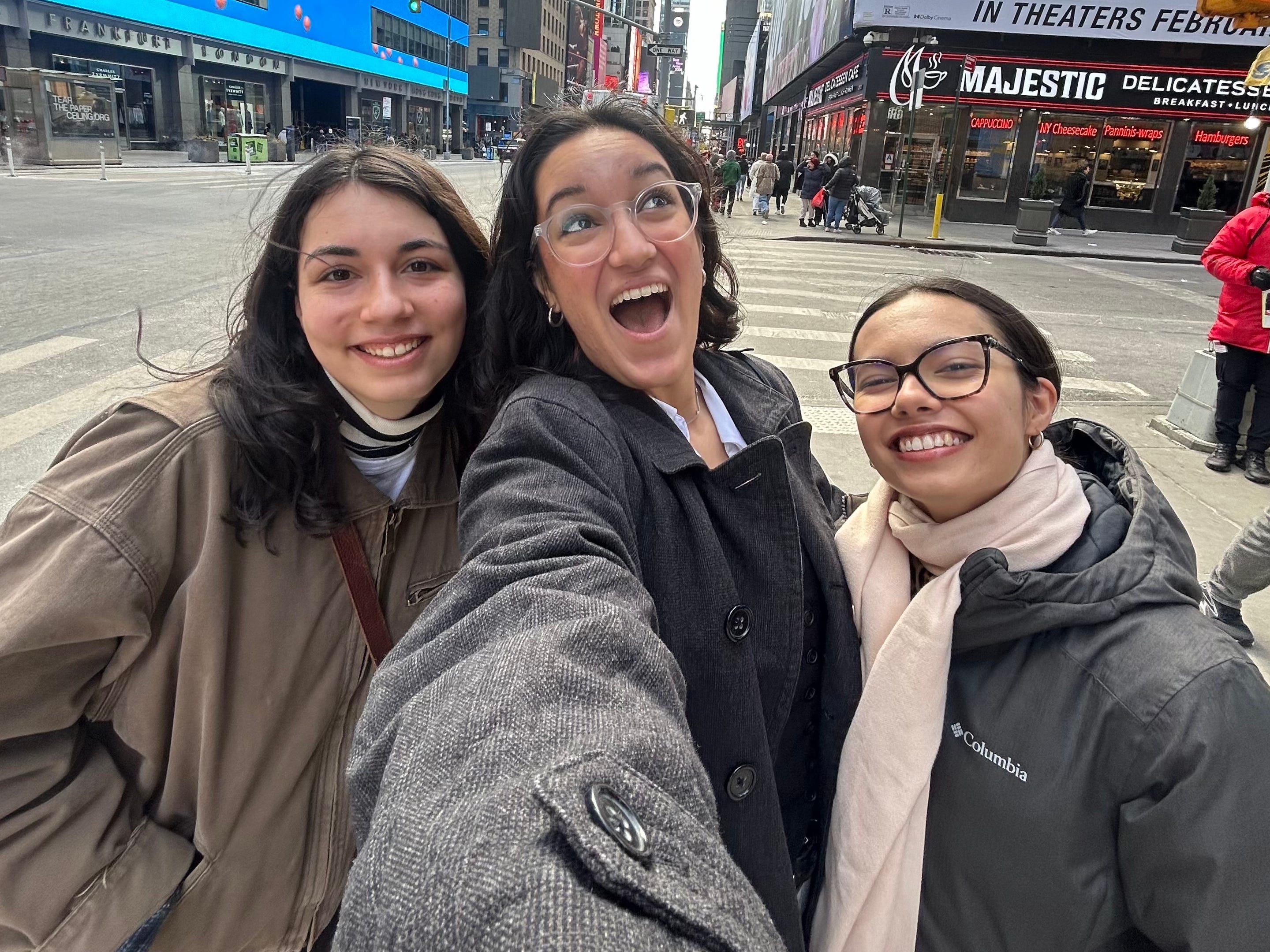 The author (left) smiling for a photo with two friends in New York City.