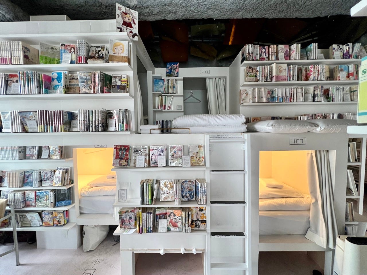 Hostel with bookshelves, capsule-style bunks