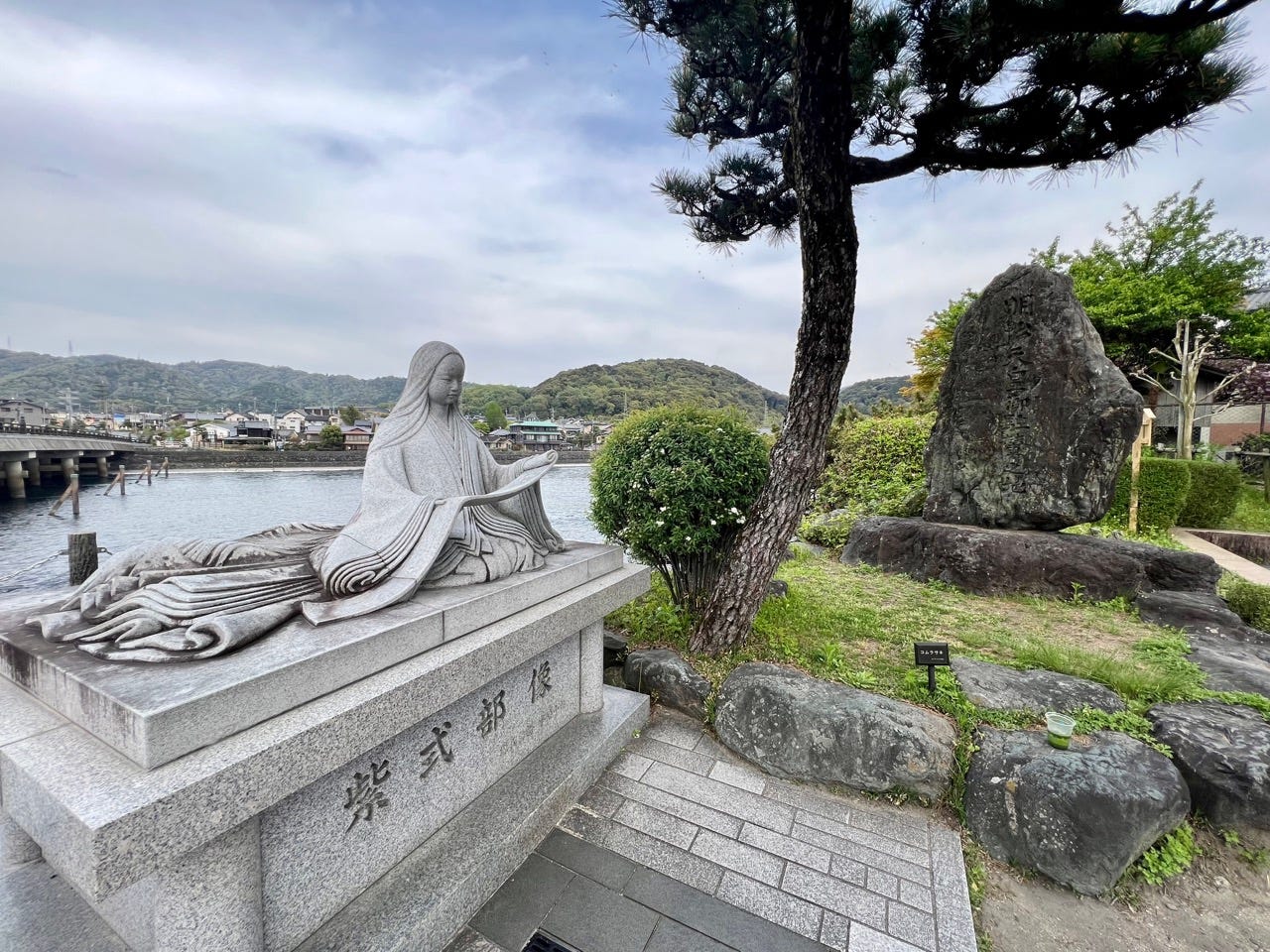 A statue of a person holding a scroll in Japan
