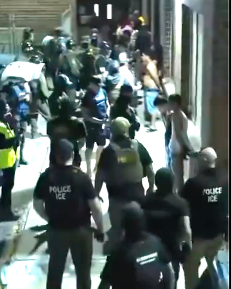 A still from the DHS raid video, showing the chaos outside the building.
