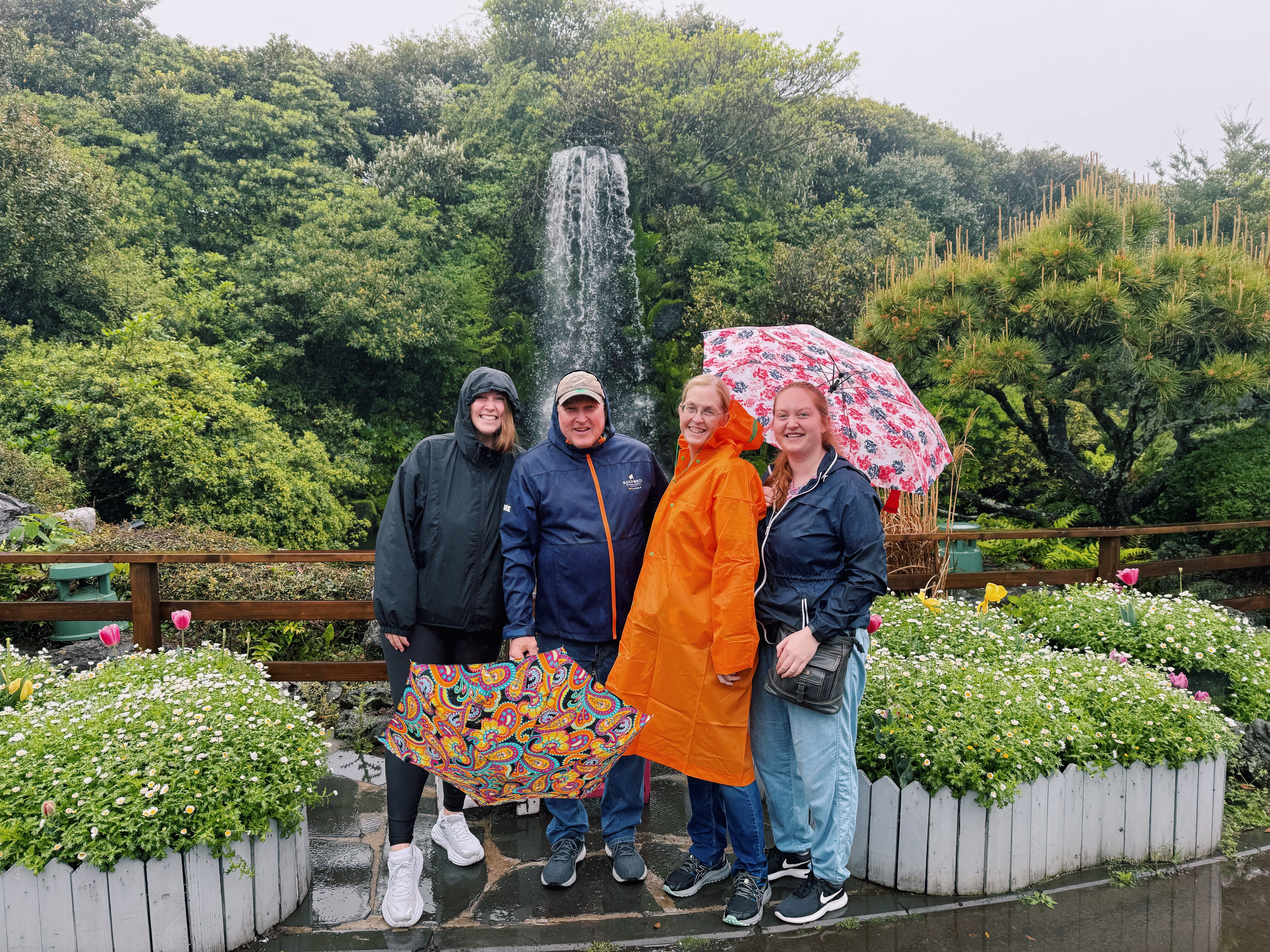 Author Allie Hubers with her sister, parents smiling in rain