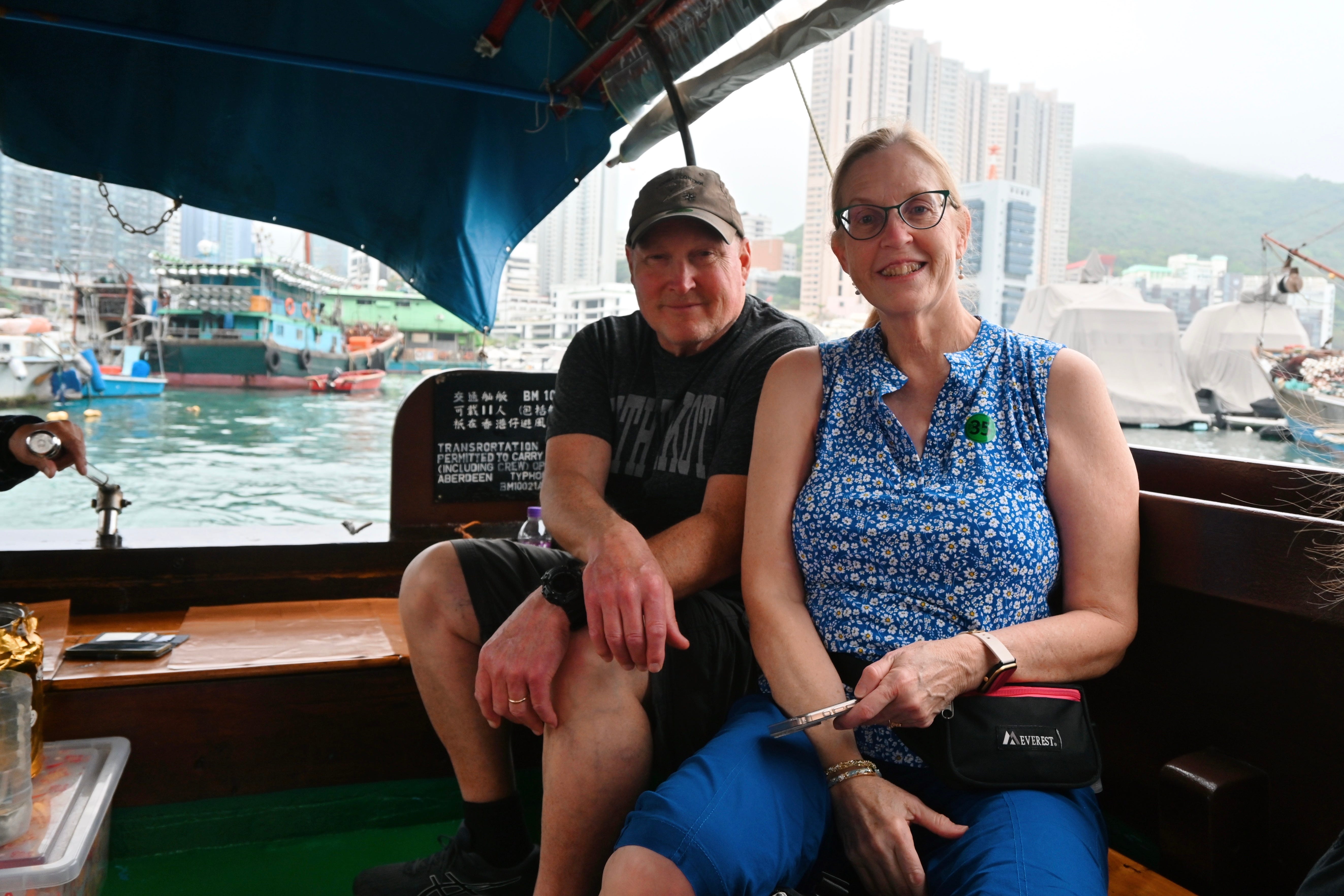 Author's parents smiling on small boat