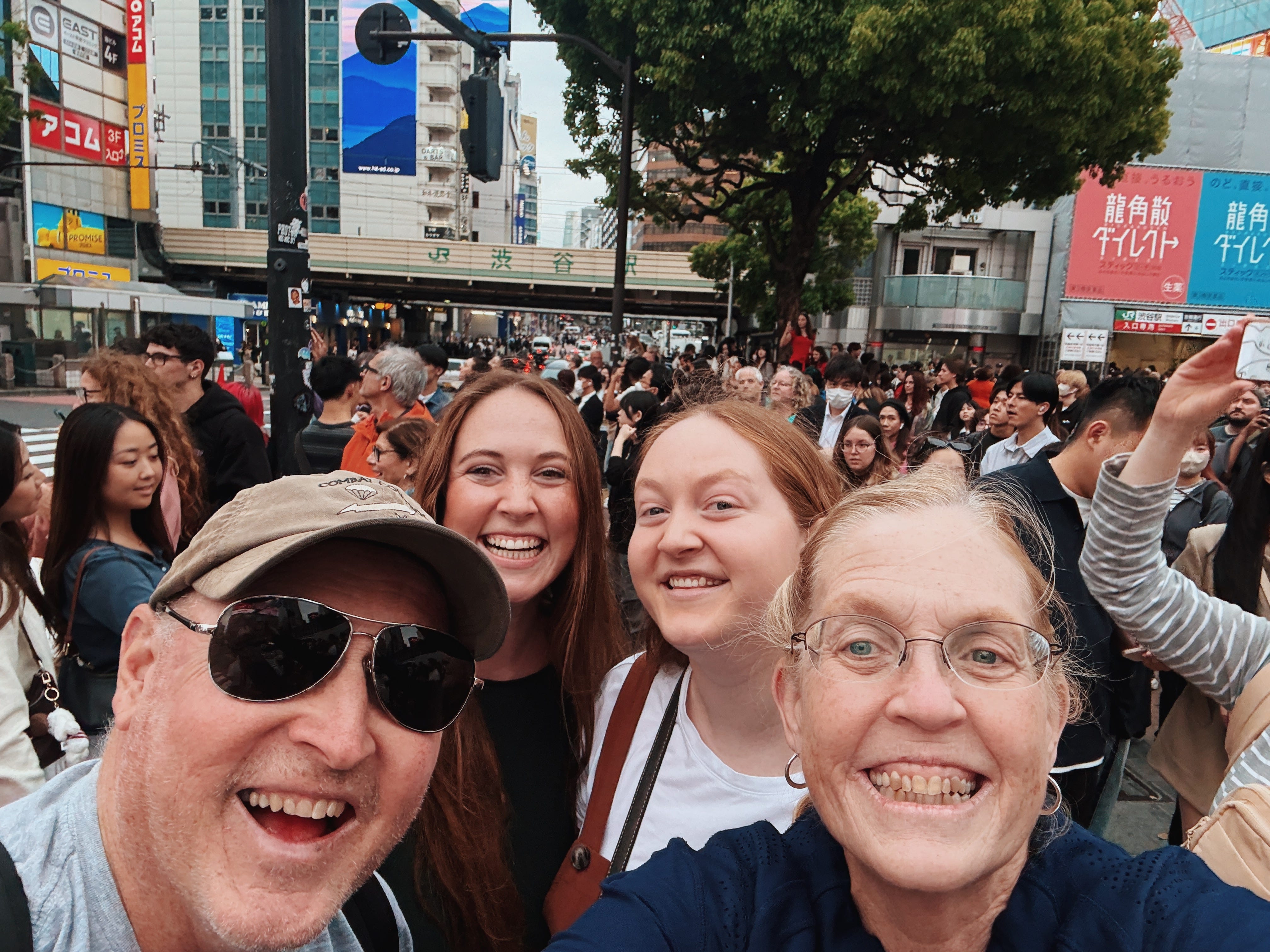Author Allie Hubers with her mom, dad, sister in crowd of people in Tokyo