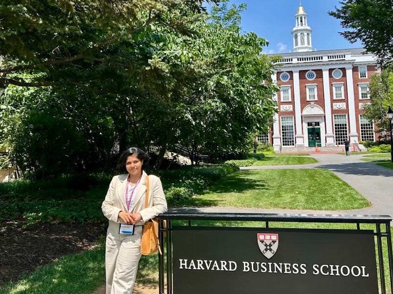 Shreya Mishra Reddy next to a Harvard Business School sign