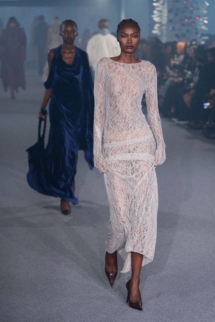 A model in a sheer white lace gown walks the runway at the Vetements Paris Womenswear Spring-Summer 2025 show.