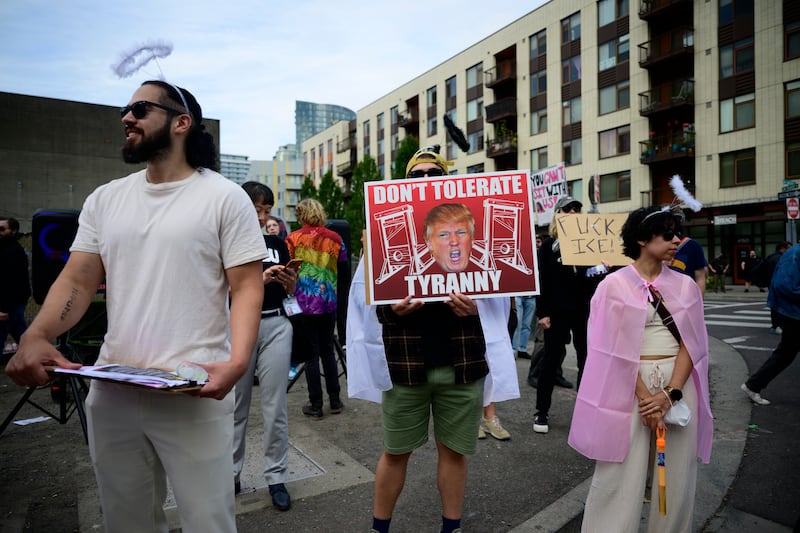 PORTLAND, OREGON - SEPTEMBER 28: Protesters hold signs outside of the U.S. Immigration and Customs Enforcement building on September 28, 2025 in Portland, Oregon. In a Truth Social post on September 27th, President Trump authorized the deployment of military troops to "protect War ravaged Portland, and any of our ICE Facilities under siege from attack by Antifa, and other domestic terrorists." (Photo by Mathieu Lewis-Rolland/Getty Images)