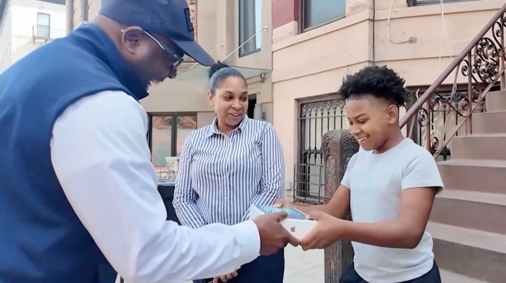 Deputy Mayor Kaz Daughtry gifts Amir Nur an iPad.