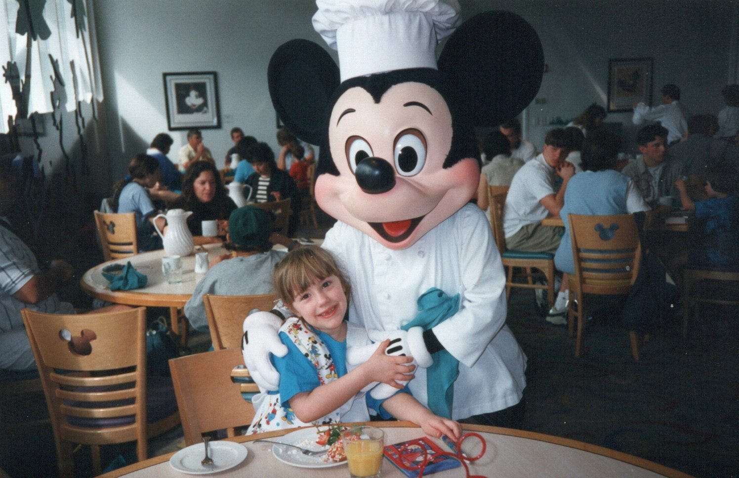 The author poses with Mickey Mouse in 1997