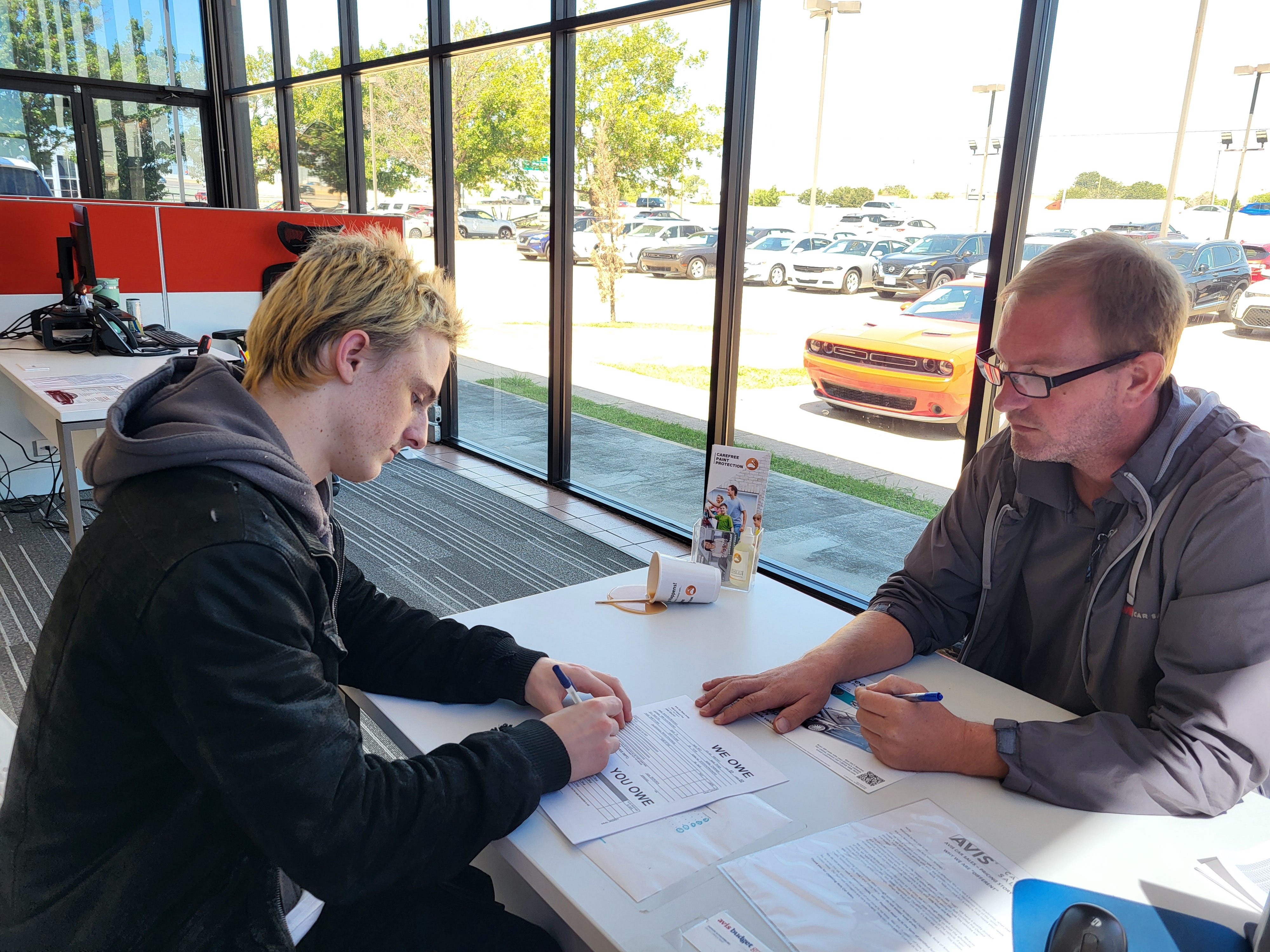 Young man buying a car
