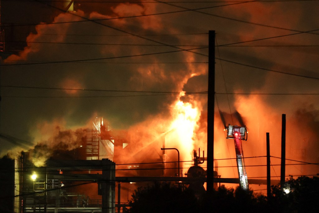 A firefighting crew works to contain a fire at the Fire Chevron Products Company El Segundo Refinery.