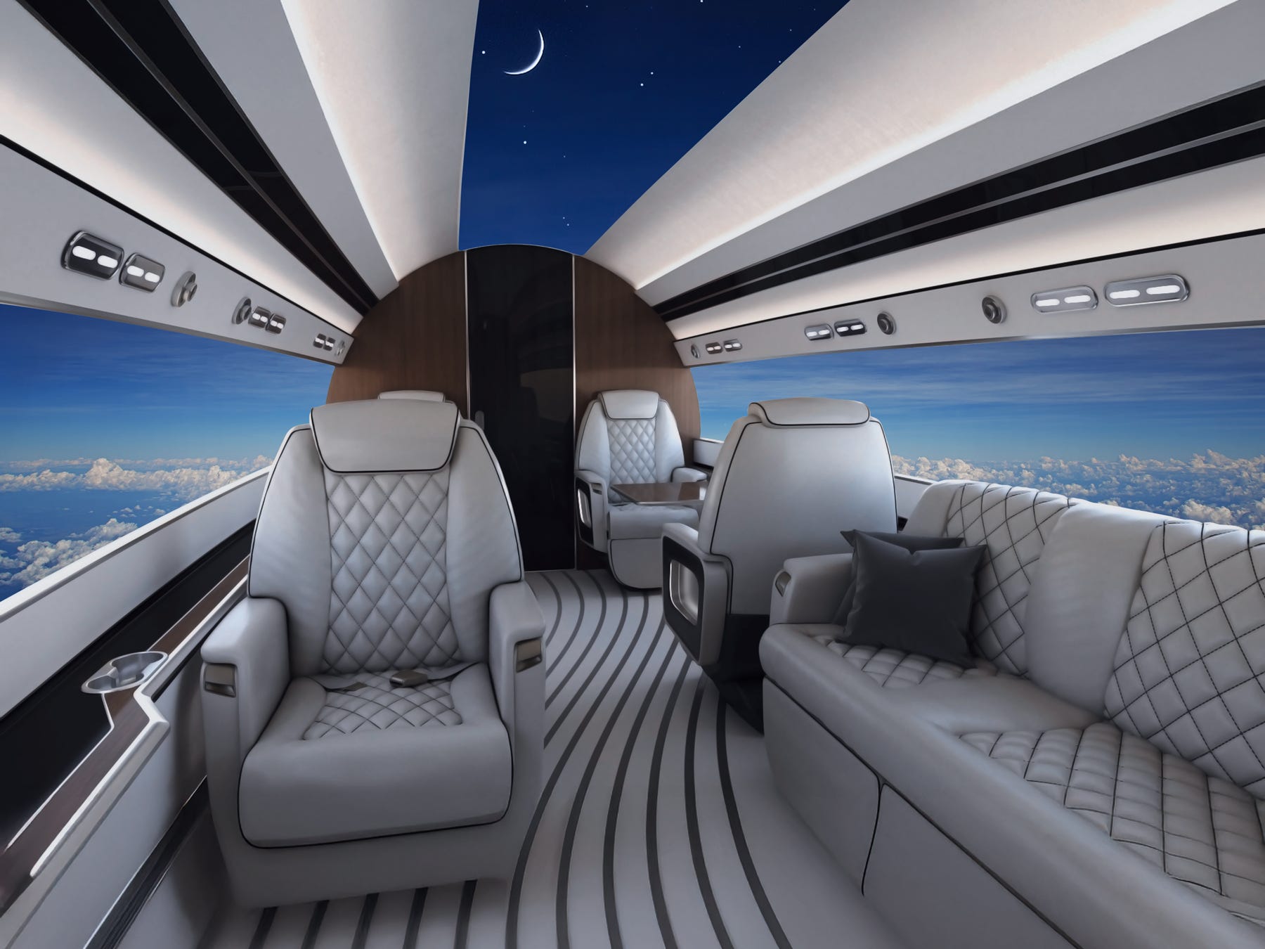 The interior of the Phantom 3500, including gray seats and a couch and the screens showing sky and clouds.