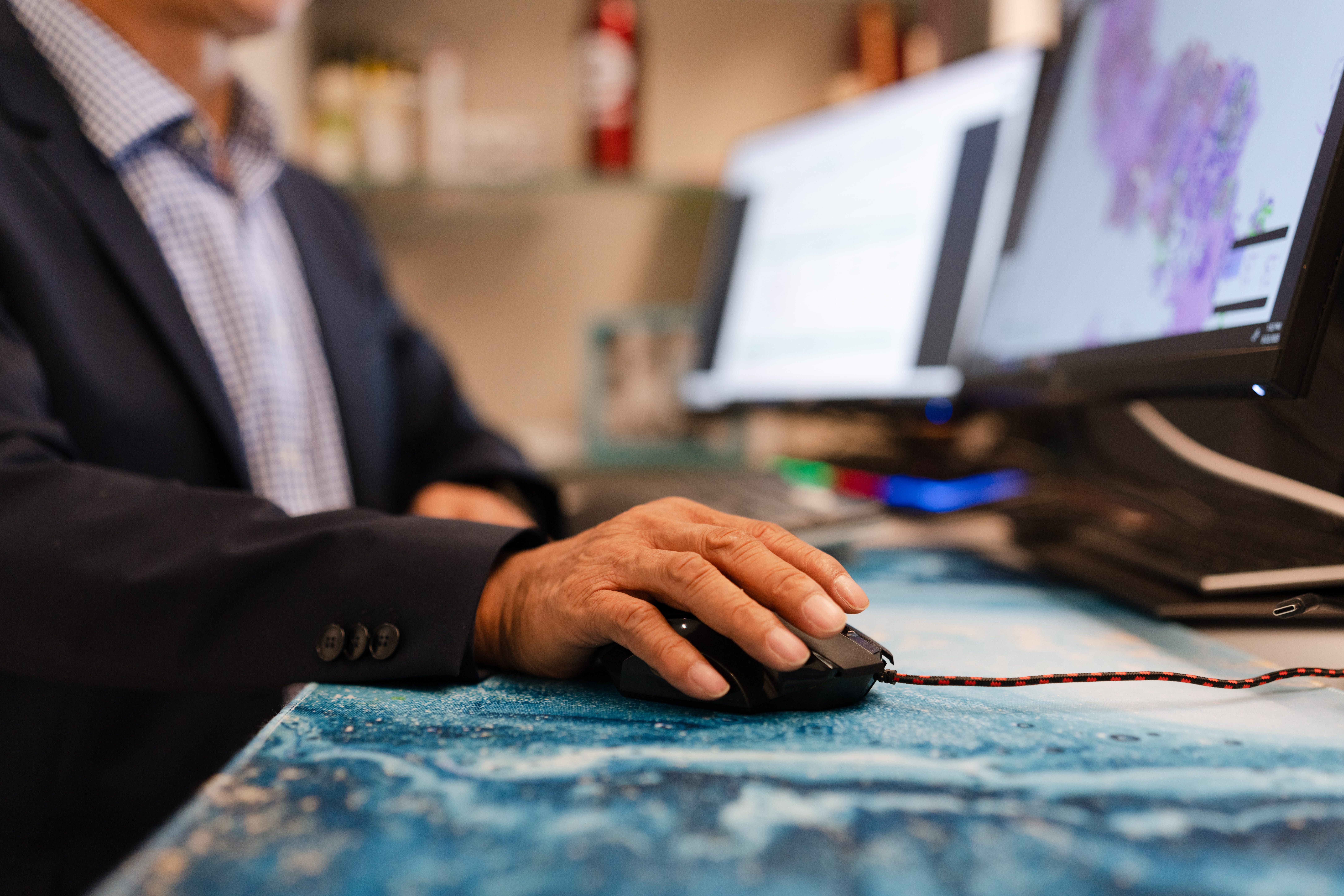 Dr. David Zhang's hand on the computer mouse
