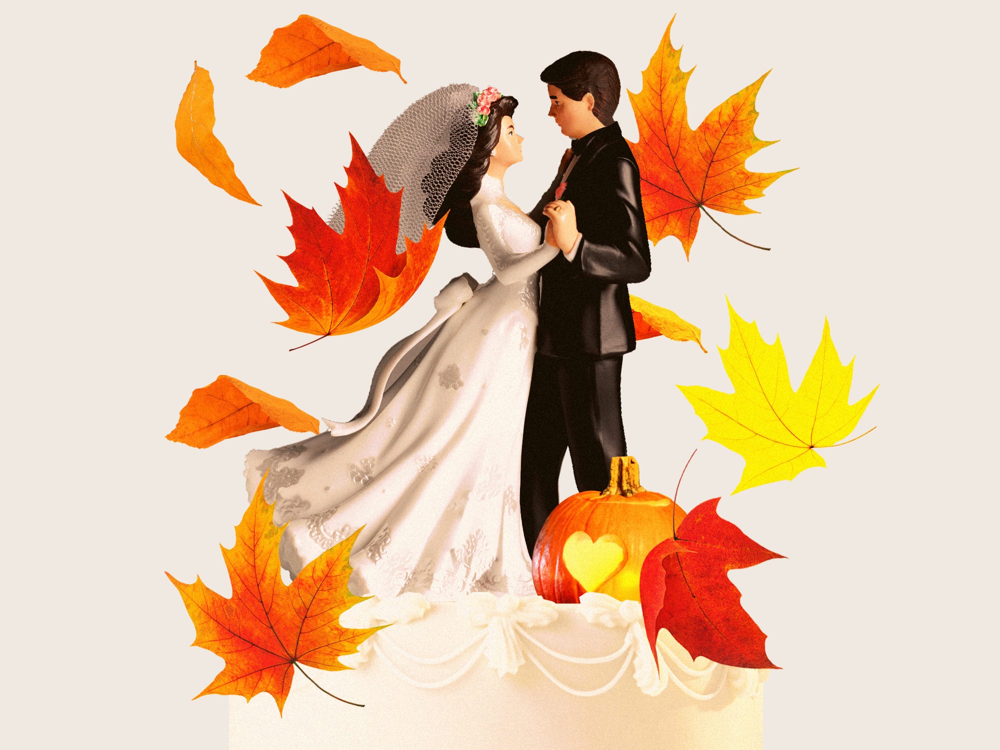 Wedding cake with dancing cake toppers, featuring a pumpkin with a carved heart, surrounded by falling leaves.