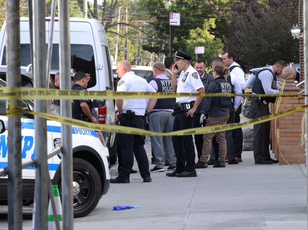 NYPD police and detectives investigating a crime scene at 45-18 Smart Street in Queens.