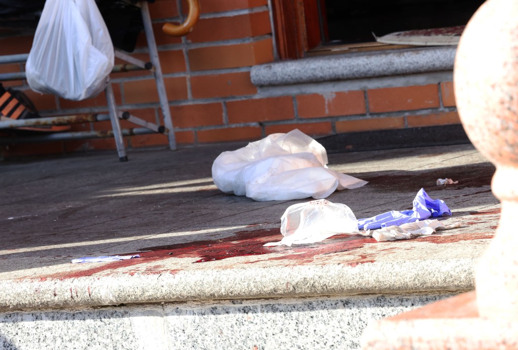 Bloodstains on the ground outside a house at 45-18 Smart Street in Queens