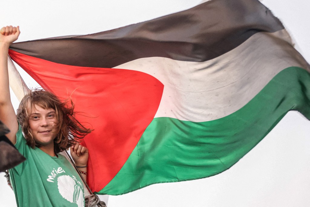 Greta Thunberg holding a Palestinian flag on a ship off Crete island, Greece.