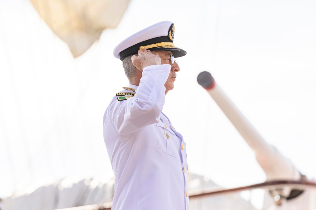 A Mexican Navy officer in white uniform salutes on Pier 86 in Manhattan on Saturday.