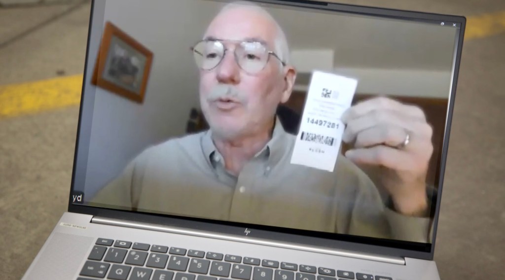Jim Boyd shows the $19,824 parking receipt he was mistakenly charged after parking for just 27 minutes at Denver International Airport.