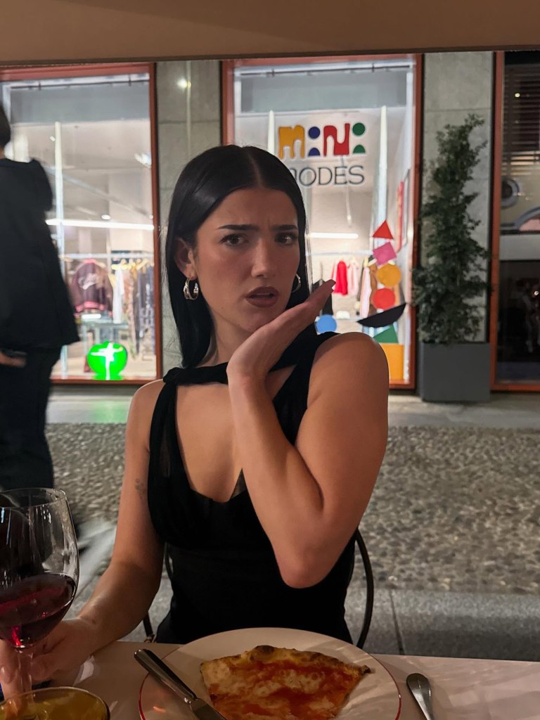 Influencer Charli D’Amelio looks skeptical of her dinner in Milan, Italy.
