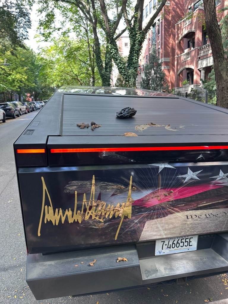 Dog poop smeared on the back of a Cybertruck with a Donald Trump signature.