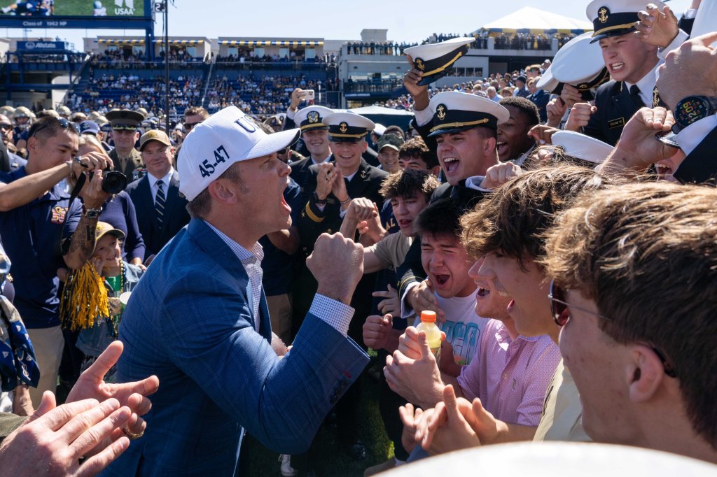 Secretary of War Pete Hegseth hypes up a crowd of midshipmen at the Navy vs. Air Force football game.
