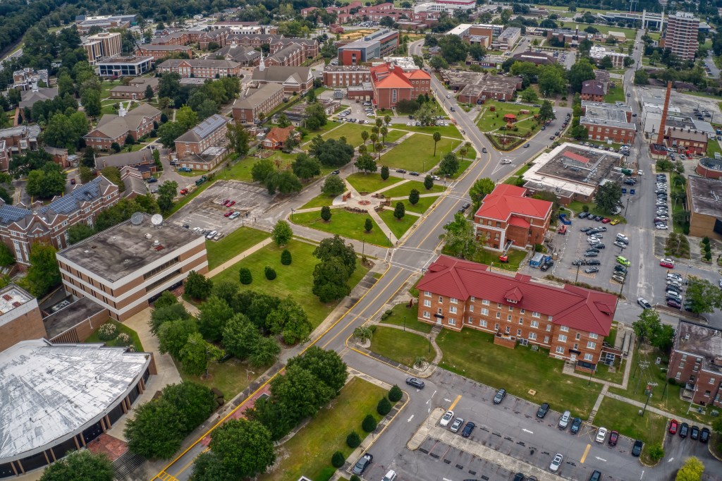 Aerial view of a large public State University in Orangeburg, South Carolina, with many buildings and trees.