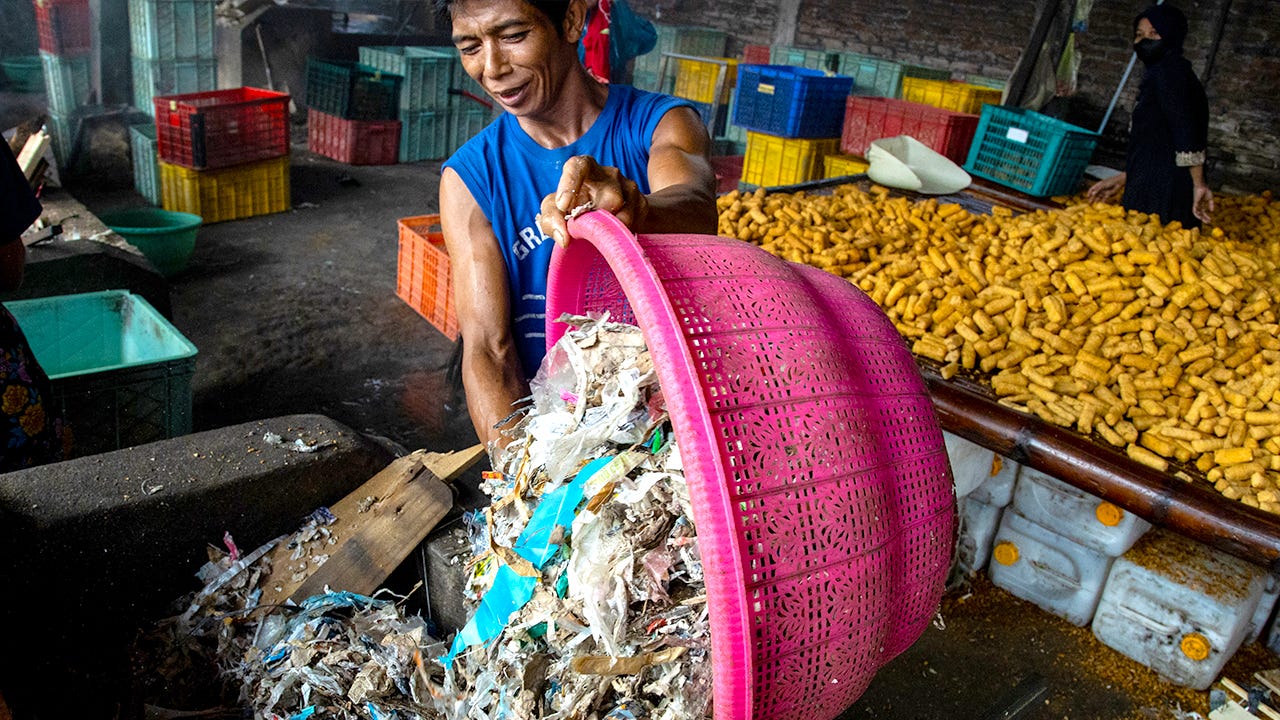 Man with basketful of trash