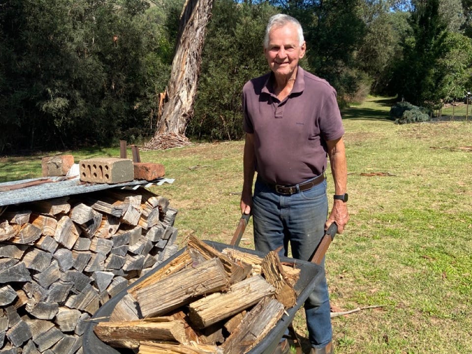 Frank Noble with wheelbarrow of wood