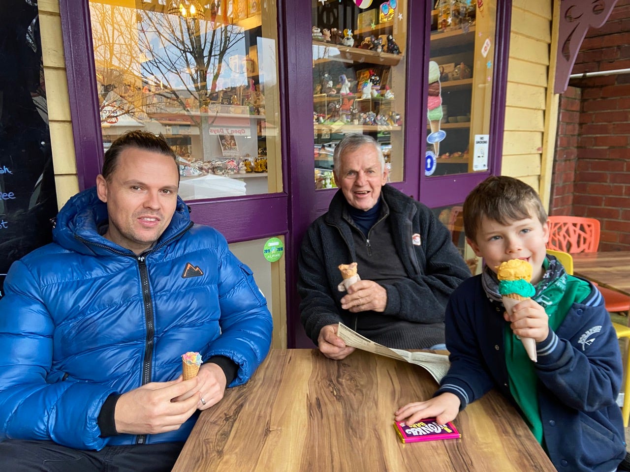 Man with his son, grandson at ice cream parlor