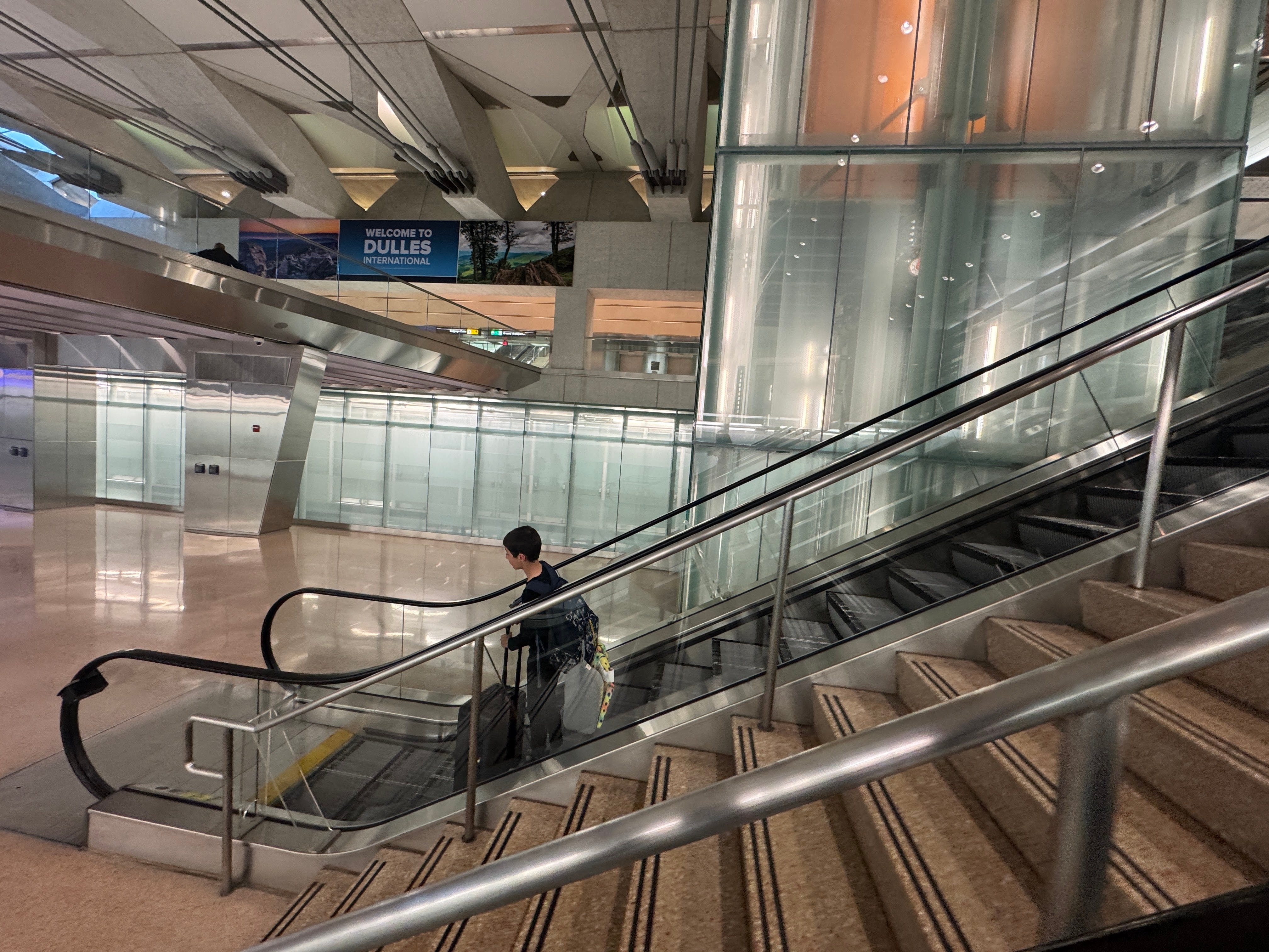 Stairs and escalators with one person on them