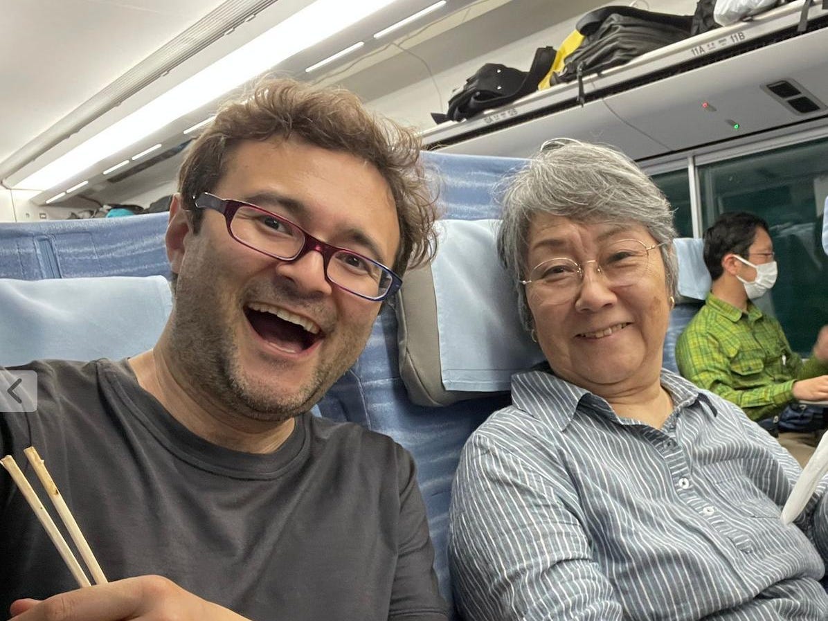 A man and a woman taking a selfie in a train.