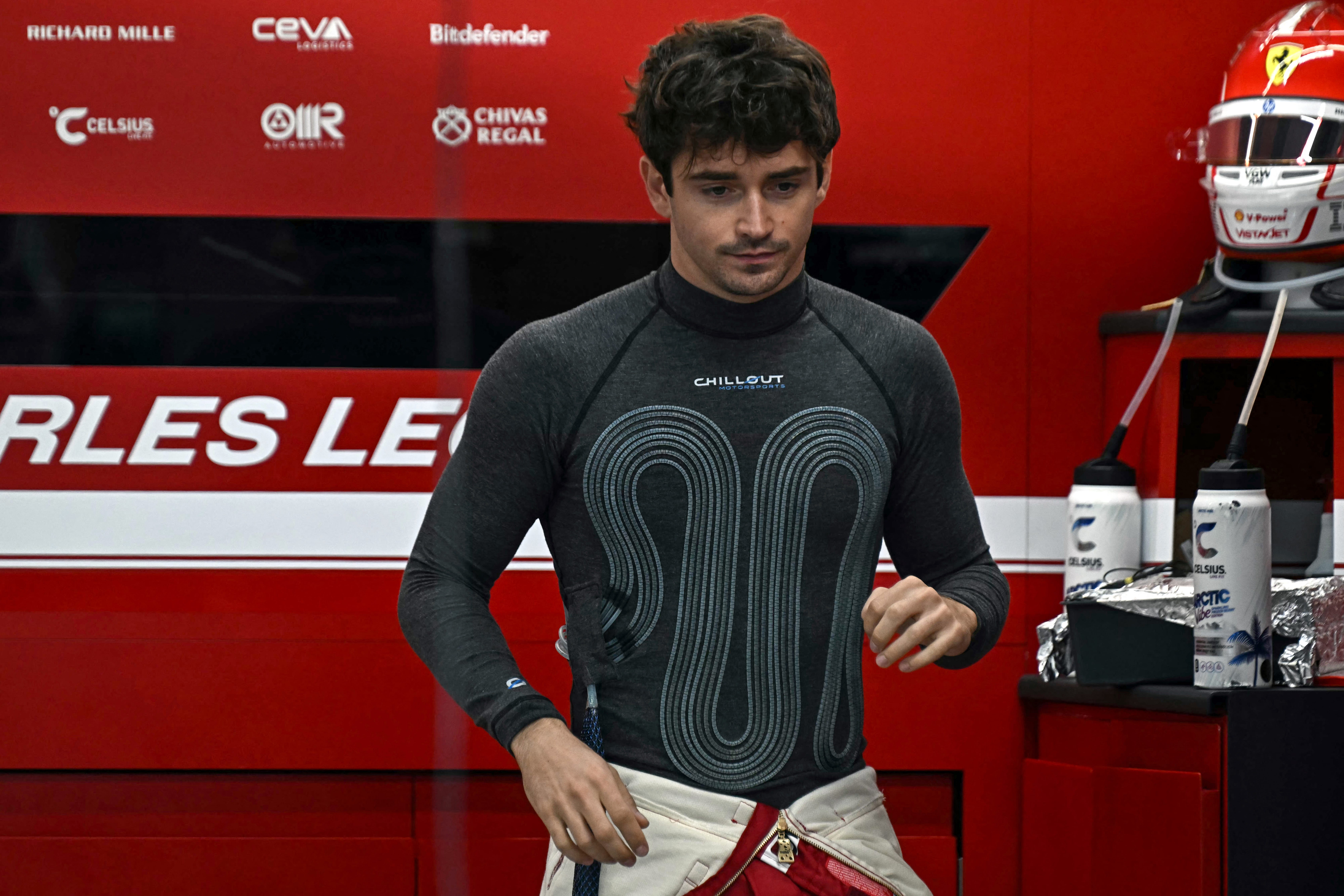 Ferrari's Monegasque driver Charles Leclerc wears a cooling vest to keep body temperature down during the first practice session ahead of the Formula One Singapore Grand Prix night race at the Marina Bay Street Circuit in Singapore on October 3, 2025.