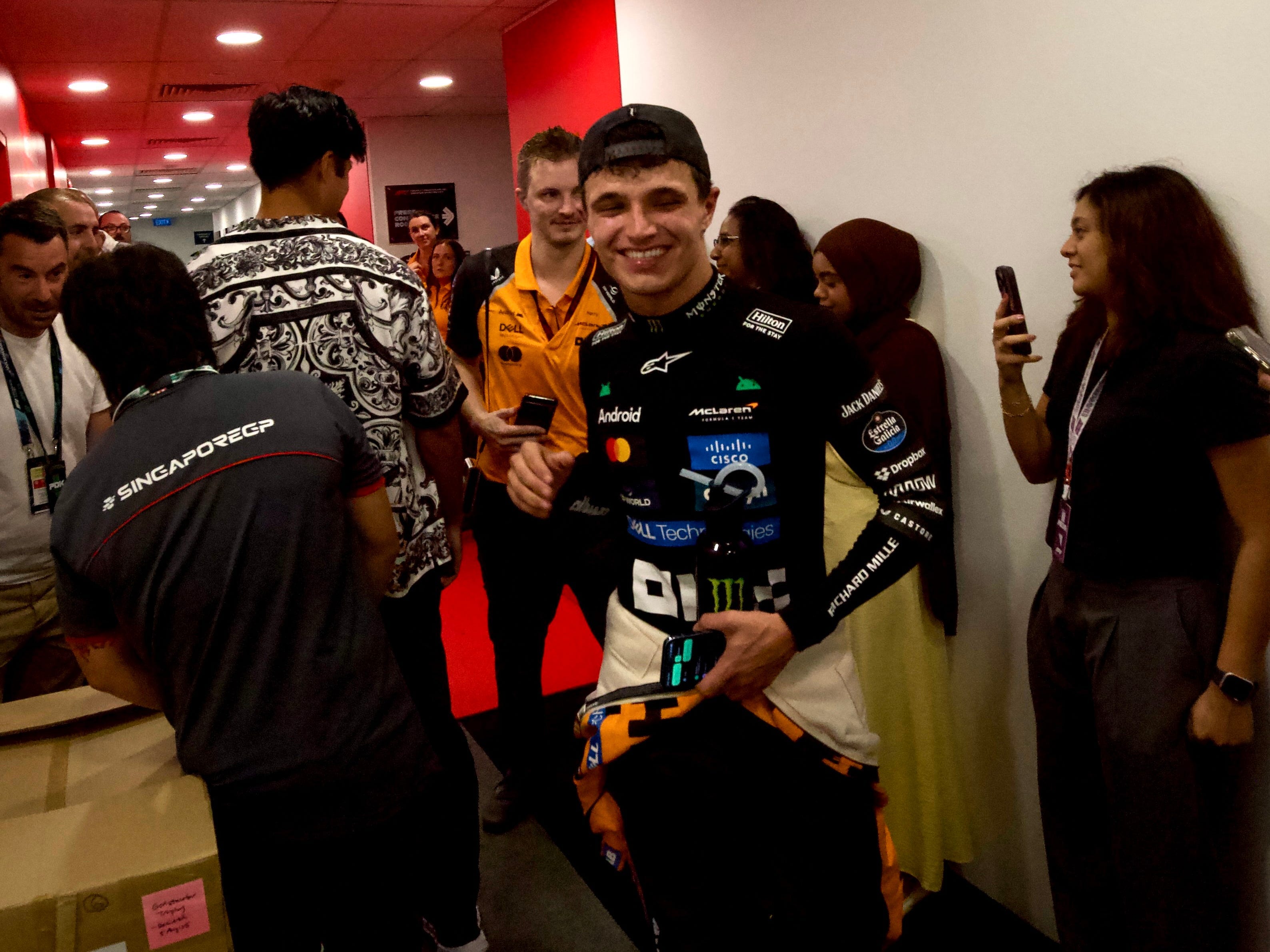 Lando Norris, first drenched in sweat from the race, was then drenched in Champagne after clinching a third spot on the podium.